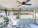 Inviting sunroom featuring a ceiling fan and views of the private, lush backyard at 1311 Abscott St, Port Charlotte, FL 33952