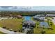 Scenic aerial view of a waterfront community with a tennis court and boat docks surrounded by lush landscaping at 1335 Rock Dove Ct # 52, Punta Gorda, FL 33950