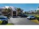 Condo exterior with ample parking, near tennis courts and lush green grass at 1335 Rock Dove Ct # 52, Punta Gorda, FL 33950