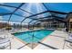 Inviting screened-in community pool featuring ample seating for relaxing and enjoying the sun at 1335 Rock Dove Ct # 52, Punta Gorda, FL 33950