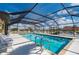 Community screened-in pool for recreation, featuring a turquoise colored pool, ladder, and patio seating at 1335 Rock Dove Ct # 52, Punta Gorda, FL 33950