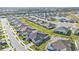 An aerial perspective showcases a neighborhood's neatly arranged homes, green spaces, and well-maintained streets at 16300 Coconut Palm Dr, Port Charlotte, FL 33953