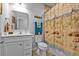 Bathroom with a single vanity, toilet, and a shower featuring a decorative beach-themed curtain at 16300 Coconut Palm Dr, Port Charlotte, FL 33953