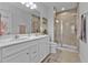 Bathroom featuring double sink vanity, modern fixtures, and a glass-enclosed shower at 16300 Coconut Palm Dr, Port Charlotte, FL 33953