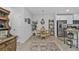 Cozy dining area adjacent to the kitchen, featuring a round wooden table, four chairs, and stylish decor, bathed in natural light at 16300 Coconut Palm Dr, Port Charlotte, FL 33953