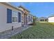 The home's front entrance features stone work, a brick paver path and professional landscaping at 16300 Coconut Palm Dr, Port Charlotte, FL 33953