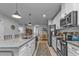 Bright, modern kitchen showcasing a granite island, stainless steel appliances, and white cabinetry, flowing into the dining area at 16300 Coconut Palm Dr, Port Charlotte, FL 33953