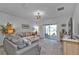 Cozy living room with a ceiling fan, sliding glass doors and neutral carpeting at 16300 Coconut Palm Dr, Port Charlotte, FL 33953