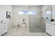 Modern bathroom with marble shower and double vanity at 16506 Cape Horn Blvd, Punta Gorda, FL 33955