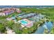 Aerial view showcasing the community pool and tennis courts surrounded by natural beauty at 1710 Starling Dr # 102, Sarasota, FL 34231