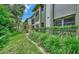 Manicured landscaping surrounding a multifamily building with well-maintained lawn creating curb appeal at 1710 Starling Dr # 102, Sarasota, FL 34231