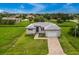 Property view showcasing home's landscaping and neighborhood at 17200 Mint Ln, Punta Gorda, FL 33955