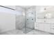 Bathroom with walk-in shower, double vanity, and marble-look floors at 17200 Mint Ln, Punta Gorda, FL 33955