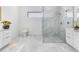 Bathroom with walk-in shower, double vanity, and marble-look floors at 17200 Mint Ln, Punta Gorda, FL 33955