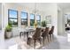 Elegant dining room with modern table, chairs, and natural light at 17200 Mint Ln, Punta Gorda, FL 33955