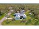 Wide aerial perspective of the house with a pool, well manicured lawn, and mature landscaping at 18181 Bly Ave, Port Charlotte, FL 33948