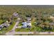 An elevated view of the home, showcasing the surrounding mature trees and tropical landscaping at 18181 Bly Ave, Port Charlotte, FL 33948