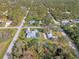 Aerial view of a residential area showcasing homes nestled among lush greenery and quiet streets at 18181 Bly Ave, Port Charlotte, FL 33948