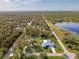 Aerial view of a home on an oversized lot, featuring mature trees and a long driveway at 18181 Bly Ave, Port Charlotte, FL 33948