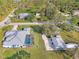 An aerial image of the property and neighborhood, highlighting the home's screened in pool and outdoor space at 18181 Bly Ave, Port Charlotte, FL 33948