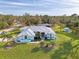 Blue house and landscaping are shown in this property's aerial view at 18181 Bly Ave, Port Charlotte, FL 33948