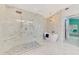 Spacious bathroom featuring a glass enclosed shower and a freestanding tub at 18181 Bly Ave, Port Charlotte, FL 33948