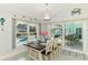 Cozy dining area featuring a wood table, seating for six, and views of the backyard pool area at 18181 Bly Ave, Port Charlotte, FL 33948