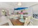 Bright dining room with cathedral ceiling, view to updated kitchen, and lots of natural light at 18181 Bly Ave, Port Charlotte, FL 33948