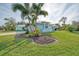 Single-story home with light blue exterior and manicured lawn at 18181 Bly Ave, Port Charlotte, FL 33948