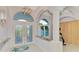 Elegant foyer featuring arched windows, decorative lighting, and tiled flooring at 18181 Bly Ave, Port Charlotte, FL 33948