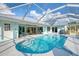 Backyard pool area with screened enclosure and outdoor seating is perfect for entertainment or relaxation at 18181 Bly Ave, Port Charlotte, FL 33948