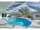 Sparkling pool with screened enclosure and surrounding patio at 18181 Bly Ave, Port Charlotte, FL 33948