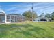 View of the pool and detached garage from the yard at 18181 Bly Ave, Port Charlotte, FL 33948