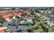 An aerial view of a community featuring a swimming pool, cabana and bright red roofs at 1890 Deborah Dr # 6, Punta Gorda, FL 33950