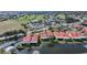 Scenic aerial view of homes by a pond and the nearby golf course offering a blend of leisure and community at 1890 Deborah Dr # 6, Punta Gorda, FL 33950