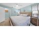 This bedroom has a light blue color scheme, with a ceiling fan, wooden furnishings, and a comfortable bed at 1890 Deborah Dr # 6, Punta Gorda, FL 33950