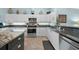 Well-lit kitchen featuring white cabinetry, stainless steel appliances, and granite countertops at 1890 Deborah Dr # 6, Punta Gorda, FL 33950