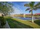 Picturesque view of a tranquil pond surrounded by lush landscaping and well-maintained homes at 1890 Deborah Dr # 6, Punta Gorda, FL 33950