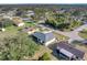 An aerial view of the home within a residential neighborhood featuring mature trees and well-manicured lawns at 20352 Tappan Zee Dr, Port Charlotte, FL 33952