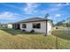 View of the backyard showcasing the home's back exterior and lawn at 20352 Tappan Zee Dr, Port Charlotte, FL 33952