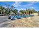 Large community swimming pool surrounded by palm trees and lounge chairs, perfect for relaxation at 20352 Tappan Zee Dr, Port Charlotte, FL 33952