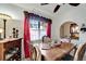 Dining room with wooden table, elegant chairs and a window with decorative curtains at 20352 Tappan Zee Dr, Port Charlotte, FL 33952