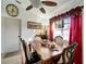 Dining room with a wooden table, comfortable chairs, and a view of the yard at 20352 Tappan Zee Dr, Port Charlotte, FL 33952