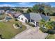 An aerial view of a well-maintained home featuring a two-car garage and a circular flower bed, showcasing curb appeal at 20352 Tappan Zee Dr, Port Charlotte, FL 33952