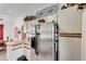 Kitchen featuring stainless steel refrigerator, ample cabinet space, and a view of the dining room at 20352 Tappan Zee Dr, Port Charlotte, FL 33952