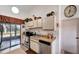 Well-lit kitchen featuring stainless steel appliances, ample cabinet space, and a view of the patio at 20352 Tappan Zee Dr, Port Charlotte, FL 33952