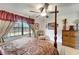 Main bedroom featuring a four poster bed, fan, and serene outdoor views at 20352 Tappan Zee Dr, Port Charlotte, FL 33952