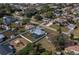 Aerial shot of a neighborhood featuring a home with a screened-in pool and fenced-in yard at 20431 Calder Ave, Port Charlotte, FL 33954