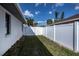 View of the backyard featuring white fencing and partial home view at 20431 Calder Ave, Port Charlotte, FL 33954