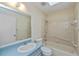 Bathroom with blue vanity, light tile and shower and bathtub combination at 20431 Calder Ave, Port Charlotte, FL 33954